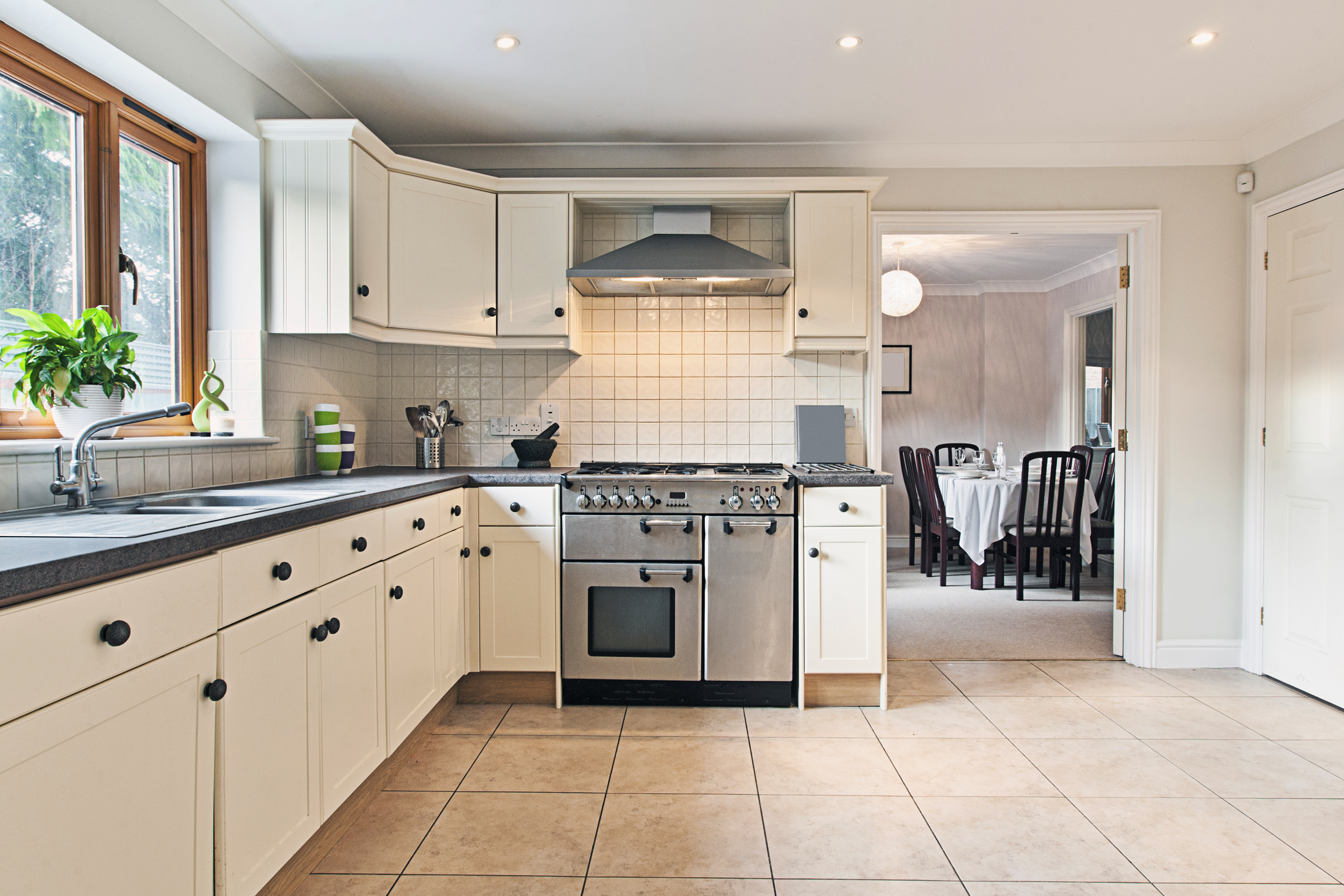 A white kitchen with grey counter tops